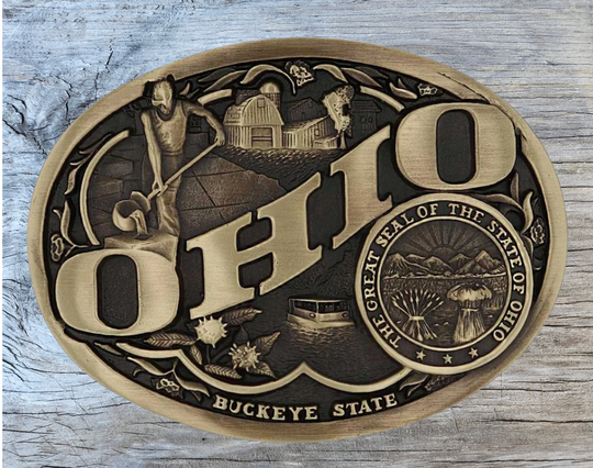 Large lettering spelling out North Carolina stretches boldly across, surrounded by a set of antiqued figures in celebration of North Carolina heritage including Cape Hatteras Lighthouse, an airplane, and the state seal. Our cast belt buckles are acid washed to add the dark antiqued patina and hand buffed to bring out the highlights and details. Standard 1.5 inch belt swivel. Get yours at our local Smyrna ,TN shop.