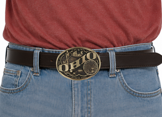 Large lettering spelling out North Carolina stretches boldly across, surrounded by a set of antiqued figures in celebration of North Carolina heritage including Cape Hatteras Lighthouse, an airplane, and the state seal. Our cast belt buckles are acid washed to add the dark antiqued patina and hand buffed to bring out the highlights and details. Standard 1.5 inch belt swivel. Get yours at our local Smyrna ,TN shop.