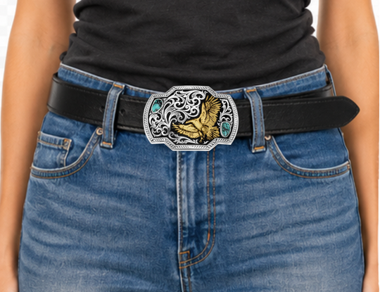 Take flight with the Tail Wind belt buckle! Featuring a black backdrop, a golden eagle soars through detailed silver filigree that mimics swirling winds. Crafted Turquoise stones add a pop of color in opposite corners of this rope-edged, rectangle buckle. Measuring about 4.25" wide by 3.25" tall, it fits belts up to 1.5" wide. Snag one at our Smyrna, TN shop—just a quick drive from downtown Nashville! Made by Montana Silversmith.