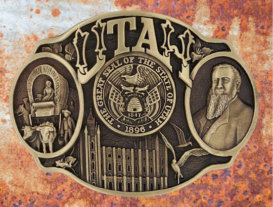 Celebrate Utah State with this buckle highlighting pioneers, Brigham Young, the Salt Lake Tabernacle, and the state seal! Brass plate over a solid cast metal alloy is antiqued and buffed to highlight the details.

Fits 1 1/2" belts and is approx. 3" tall x 4" across. Available at our shop just outside Nashville in Smyrna, TN. Made by Montana Silversmiths.