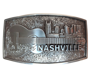 The "NASH" Buckle takes you to the beloved Nashville skyline complete with a whimsical bat tower building and an acoustic guitar. Show off your style with this 2 1/2" by 3 1/2" buckle and be inspired by the city made famous for risk-takers. Get yours online or in our Smyrna, TN shop, just outside Nashville. Dare to shine!