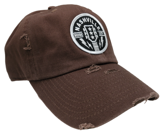 Discover the adventurous spirit of Nashville, the music city of legends! This one-of-a-kind Guitar Cap proudly features the iconic Guitar head stock with the three stars representing Tennessee. With a vintage distressed look complete with rips and tears, this cap exudes a daring and inspiring vibe. Get yours now from our store in Smyrna, TN, just a short 20-minute drive from downtown Nashville!