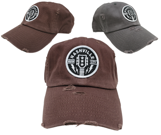 Discover the adventurous spirit of Nashville, the music city of legends! This one-of-a-kind Guitar Cap proudly features the iconic Guitar head stock with the three stars representing Tennessee. With a vintage distressed look complete with rips and tears, this cap exudes a daring and inspiring vibe. Get yours now from our store in Smyrna, TN, just a short 20-minute drive from downtown Nashville!