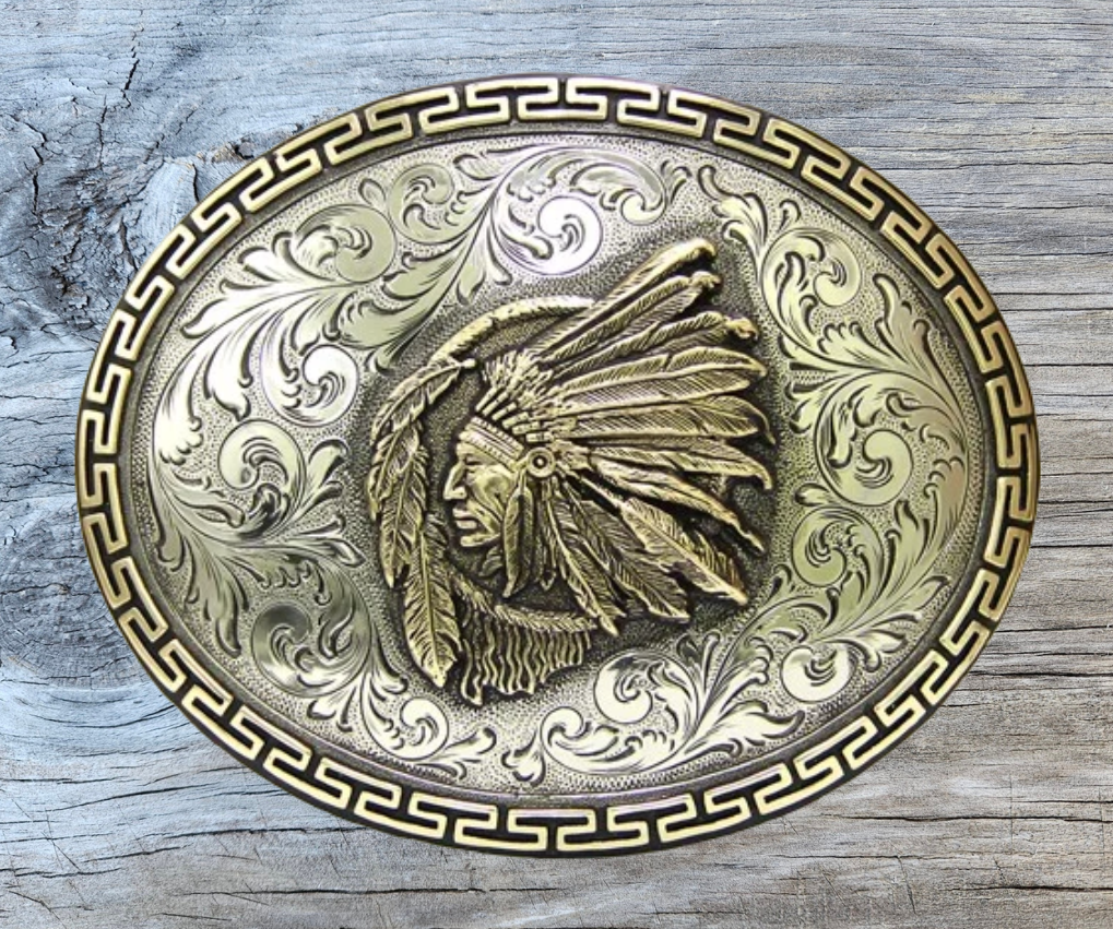 The Native Spirit is an oval buckle bordered with a continuous line of linked 52 pattern in brass. The background is an engraved western floral in silver. The center is graced with a brass Indian chief over a dream catcher. All creating an image that captures the Native Spirit. Available in our Smyrna, TN shop, a short distance from Nashville.

Dimensions: Width 4.5”, Height 3.5”
Standard 1.5” Swivel