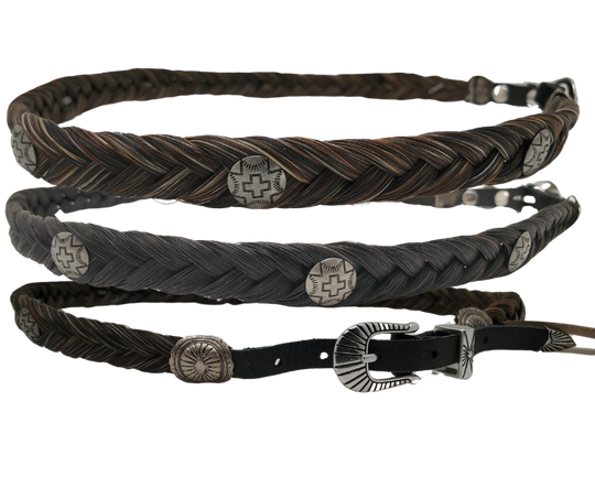 Add a touch of Navajo cross conchos to your hat by using our Authentic Horse Hair hatband, approximately 1/2 inch wide. This hatband is finished with leather ends and a 3 piece style buckle adjustable closure, and can fit most hats. It is suitable for various hat styles and western crowned hats. You can find it at our shop in Smyrna, Tn. Each piece is crafted in Montana using horsehair mainly sourced from Argentina, Mongolia, and Canada.