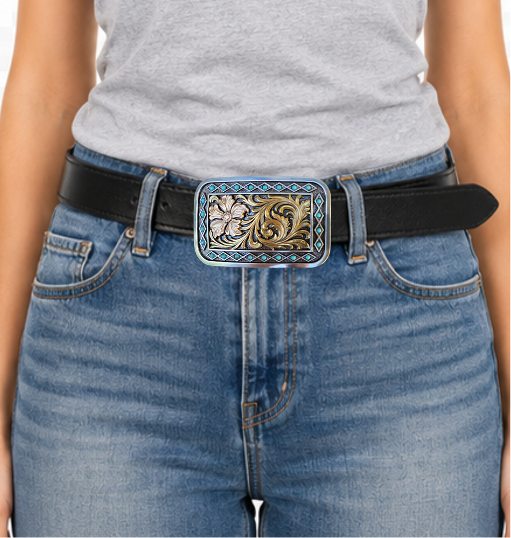 The Occidental is a rectangle buckle with a pearl copper flower and antique gold scrolling in the center. Diamond shaped filigree with turquoise stones around the smooth edge. Pearl Copper Flower, Turquoise Stones on Edge. 98% Zinc, 1% Stone, 1% Iron. Approximate Size 2 x 3-1/2. You can find it at our retail shop in Smyrna, TN, located just outside of Nashville, or online.

Measuring 2" tall by 3 1/2" wide
Fit's belts up to 1 1/2" wide.
Imported