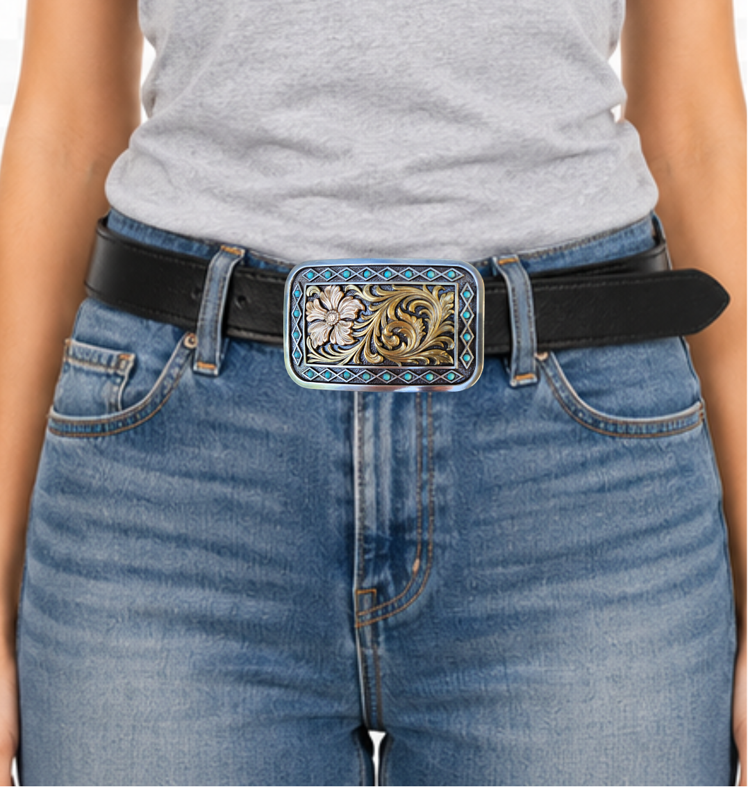 The Occidental is a rectangle buckle with a pearl copper flower and antique gold scrolling in the center. Diamond shaped filigree with turquoise stones around the smooth edge. Pearl Copper Flower, Turquoise Stones on Edge. 98% Zinc, 1% Stone, 1% Iron. Approximate Size 2 x 3-1/2. You can find it at our retail shop in Smyrna, TN, located just outside of Nashville, or online.

Measuring 2" tall by 3 1/2" wide
Fit&