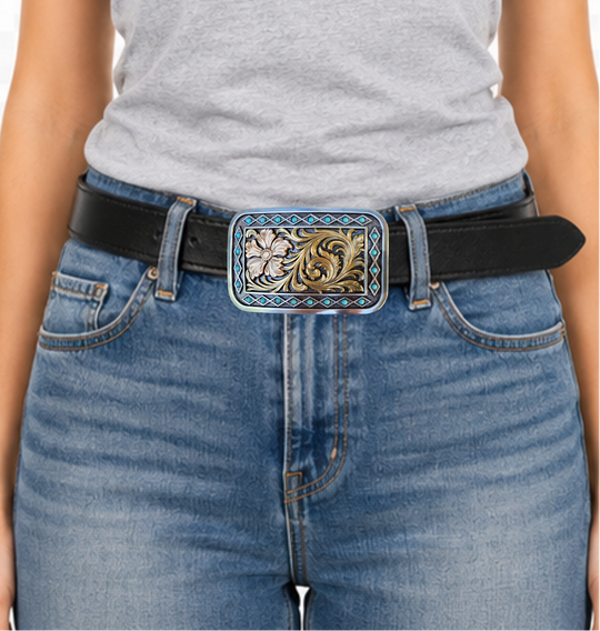 The Occidental is a rectangle buckle with a pearl copper flower and antique gold scrolling in the center. Diamond shaped filigree with turquoise stones around the smooth edge. Pearl Copper Flower, Turquoise Stones on Edge. 98% Zinc, 1% Stone, 1% Iron. Approximate Size 2 x 3-1/2. You can find it at our retail shop in Smyrna, TN, located just outside of Nashville, or online.

Measuring 2" tall by 3 1/2" wide
Fit&