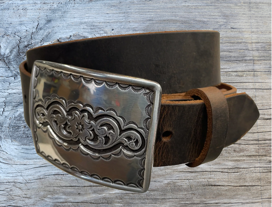 Rectangular antique silver belt buckle with western style tooling, size approx. 3" wide by 2 1/2" tall. Belt is handmade from a single strip of leather in our shop. Belt colors available are distressed brown, black, and dark brown. Buckle snaps in place for easy changing if desired.﻿ CHOOSE ONE BELT STRIP COLOR! Available online and at our shop just outside Nashville in Smyrna, TN. Main photo.