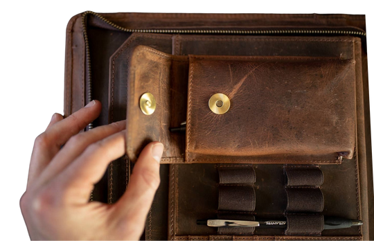 The Nomad Leather Portfolio is the perfect blend of rugged durability and professional style, designed to keep you organized wherever work takes you. Crafted from top-grain water buffalo leather, dedicated sleeve for a tablet, documents, and a letter size pad or planner insert. Whether you’re in the office, traveling, or working remotely, the Nomad Portfolio ensures you stay prepared in timeless leather craftsmanship. See them at our Smyrna, TN shop.
