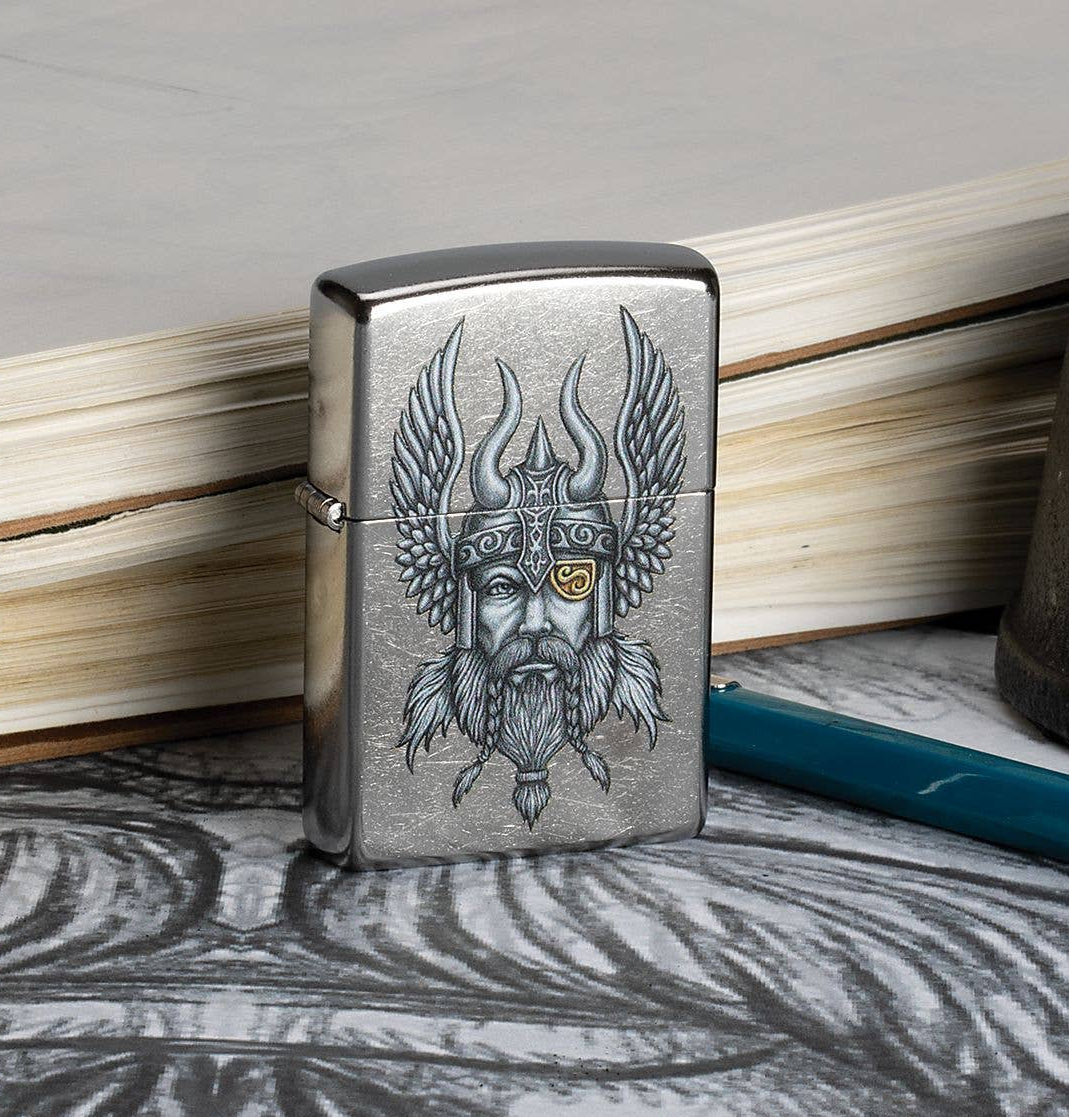 This Nordic Viking is a digitally-transferred color image on a Street Chrome™ lighter. All metal construction; windproof design works virtually anywhere. Refillable for a lifetime of use. Comes packaged in a gift box. Available in our Smyrna, TN shop.

Made in USA
Fuel: Zippo lighter fuel (sold separately)
Lighter Specs: Height: 2.25" Width: 0.5" Depth: 1.5" Weight: 2.0 oz
Lifetime guarantee that "it works or we fix it free™" Zippo contact info on gift box.