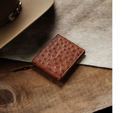 Made from authentic Cognac Ostrich leather, this bi-fold wallet blends classic western flair with bold luxury. True to Stetson’s legendary craftsmanship, it offers 6 card slots, 2 hidden pockets, and a spacious leather-lined cash compartment. Ready for you at our Smyrna, TN store, just a short drive from Nashville. Proudly made in Mexico.