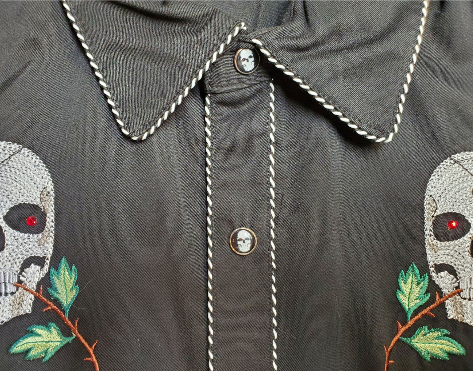 Close up - Western shirts with Skulls & Roses never go out of style! Inspired by classic cowboy movies, these timeless designs are favorites of today’s country stars and rock icons alike. Pair them with your favorite ripped jeans for a casual vibe or dress them up with sharp jeans for a night out. Just arrived at our Smyrna, TN shop, just a stone’s throw from Music Row in downtown Nashville!