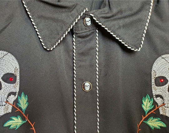 Close up - Western shirts with Skulls & Roses never go out of style! Inspired by classic cowboy movies, these timeless designs are favorites of today’s country stars and rock icons alike. Pair them with your favorite ripped jeans for a casual vibe or dress them up with sharp jeans for a night out. Just arrived at our Smyrna, TN shop, just a stone’s throw from Music Row in downtown Nashville!