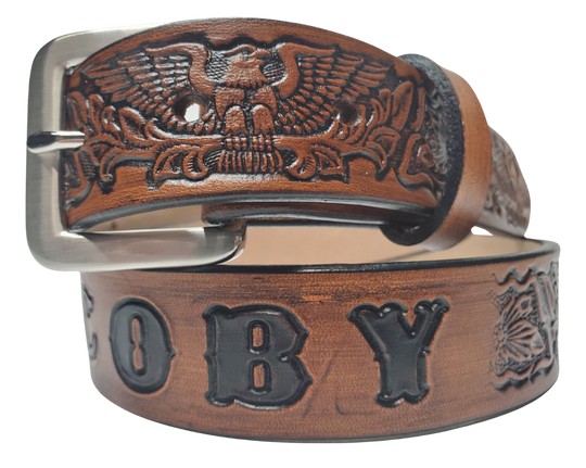 Our Patriot" Name Leather Belt is Full grain American vegetable tanned cowhide approx. 1/8"thick. Width 1 1/2" and includes Antique Nickle plated Solid Brass buckle. Hand Finished with Smooth burnished painted edges. Choose with or without name, if without name, design will cover entire length of belt. For name Type name desired on belt in "Type Name Here" section, no more than 10 letters maximum. Buckle snaps in place for easy changing if desired. Made in our Smyrna, TN, USA shop.