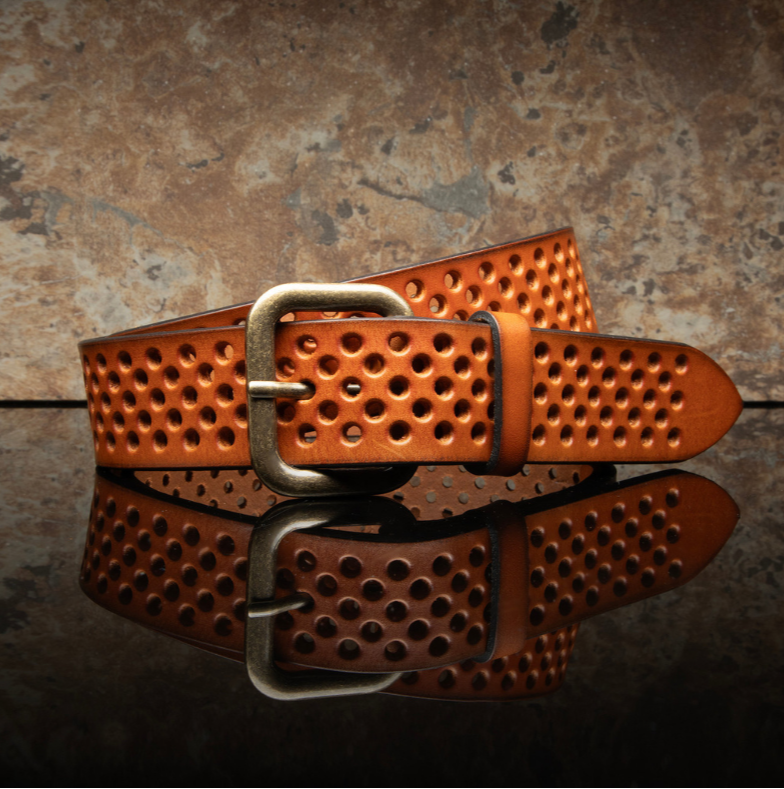 The Perforated Jean Belt - the perfect accessory to complete your outfit with style and functionality. Crafted with high-quality full-grain vegetable-tanned leather imported from Italy and crafted in Turkey,&nbsp; The steel molded hardware with an antique finish adds a touch with its adjustable fit and breathable design, the Perforated Jean Belt is suitable for all seasons. Get fitted at our Smyrna, TN shop not far from Franklin. Made by Will Leather.