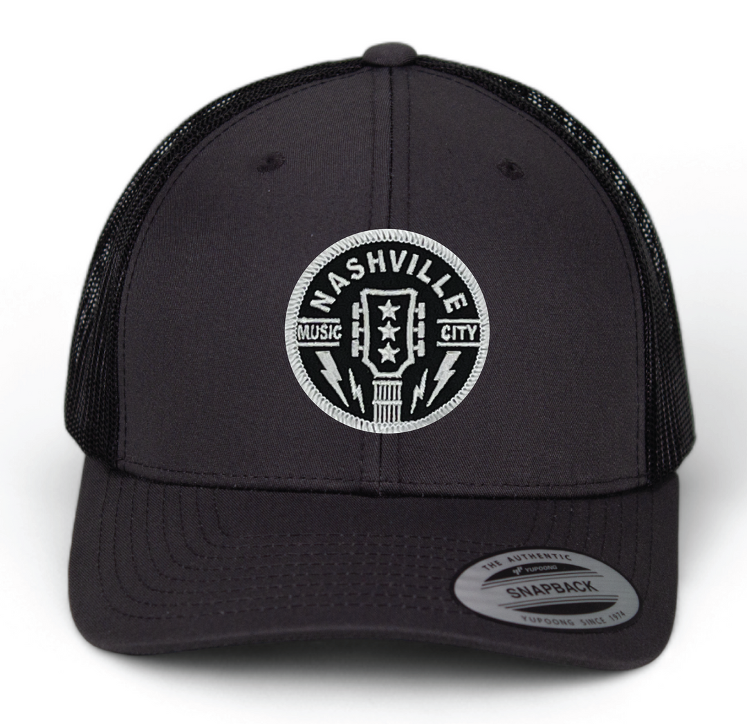 Classic Patched Cap with Music City Nashville and shape of guitar head in the center. Patch is front and center of a snapback cap. This will soon become your favorite cap! Shop now at our Smyrna, TN store or online.

snap back adjustment
Charcoal front with black mesh back