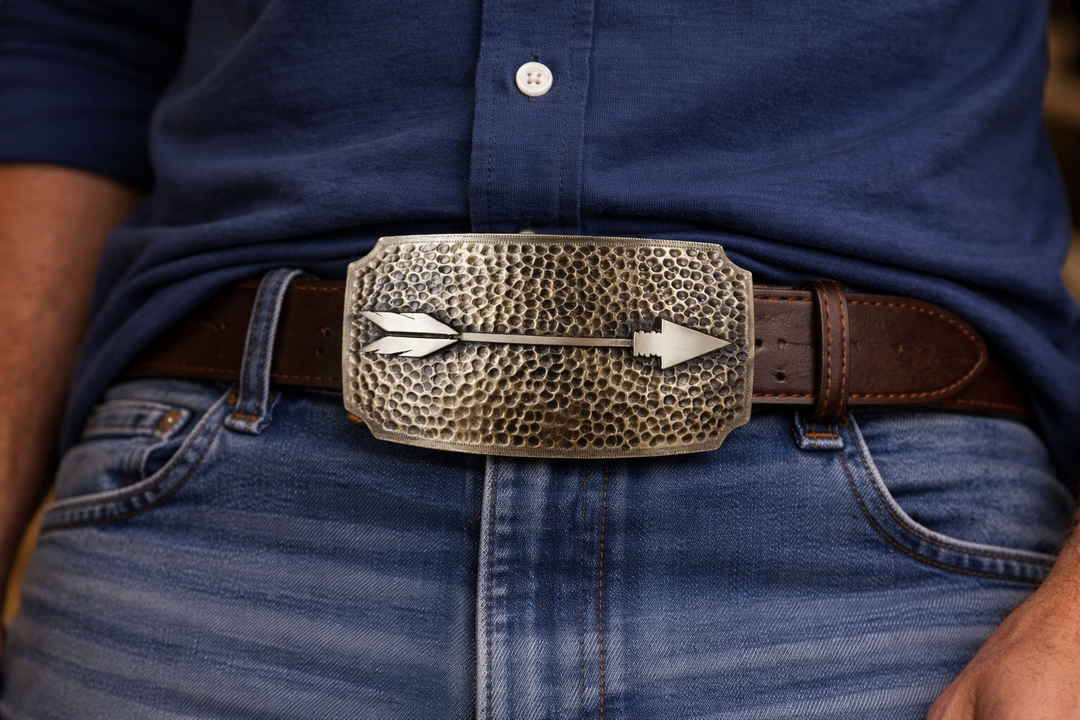 A Primal Arrow was a go-to weapon for hunting and defense, showing focus, strength, and skill. Featuring a hammered backdrop with a feathered arrow as the centerpiece. Each corner of this rectangle buckle appears to have been scooped out. Make a statement with this simple yet classic buckle, a great complement to many styles. Measuring about 2 1/2"x 3 3/4", it suits belts up to 1 3/4" wide. Swing by our Smyrna, TN shop to grab yours!