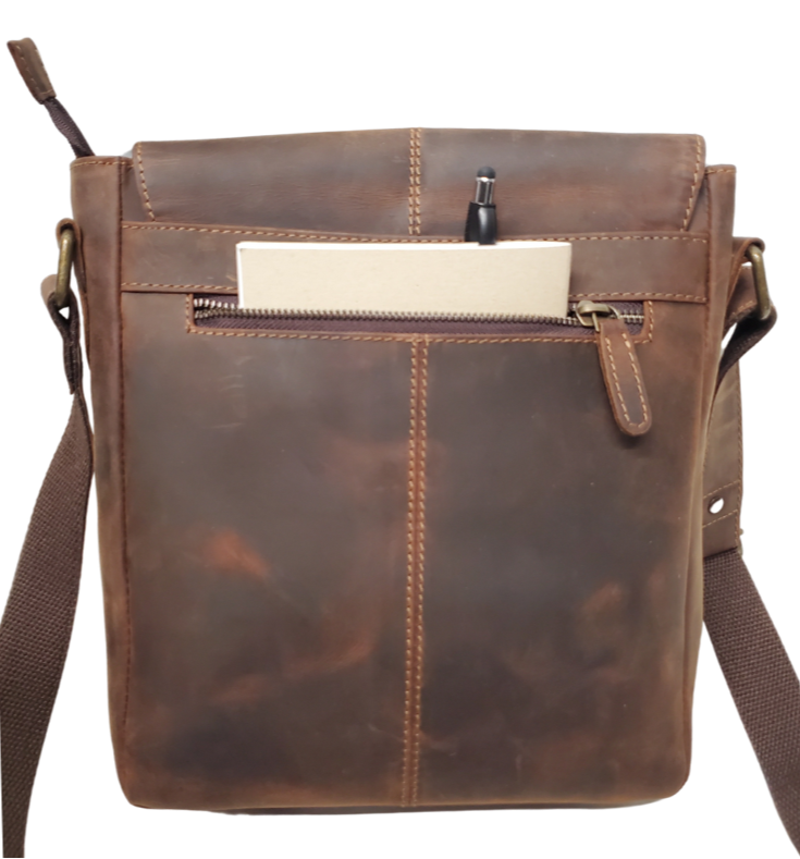 The Administrator Tablet Bag includes an adjustable leather strap strengthened by cotton webbing plus a bonus back zip pocket. Hidden under the flap's magnetic snap closure is a main zippered compartment, small zipper inside pocket, open phone pocket. Durable fabric lines the spacious interior, ensuring safe storage for all your essentials. Discover it at our Smyrna, TN store, conveniently located near Nashville.