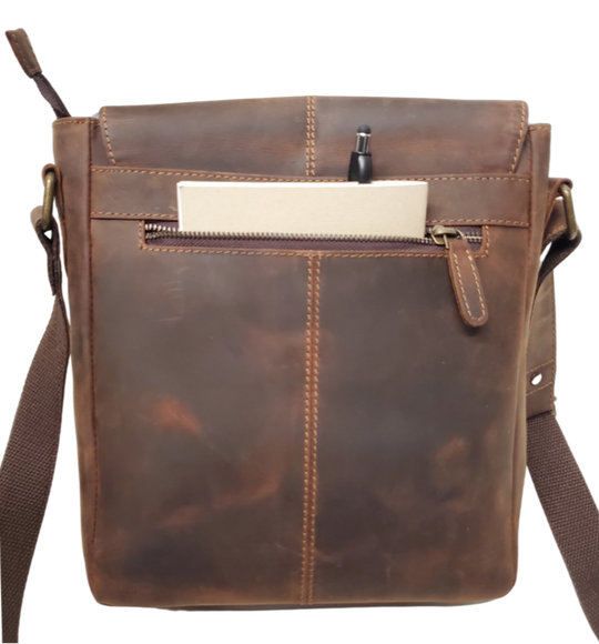 The Administrator Tablet Bag includes an adjustable leather strap strengthened by cotton webbing plus a bonus back zip pocket. Hidden under the flap's magnetic snap closure is a main zippered compartment, small zipper inside pocket, open phone pocket. Durable fabric lines the spacious interior, ensuring safe storage for all your essentials. Discover it at our Smyrna, TN store, conveniently located near Nashville.