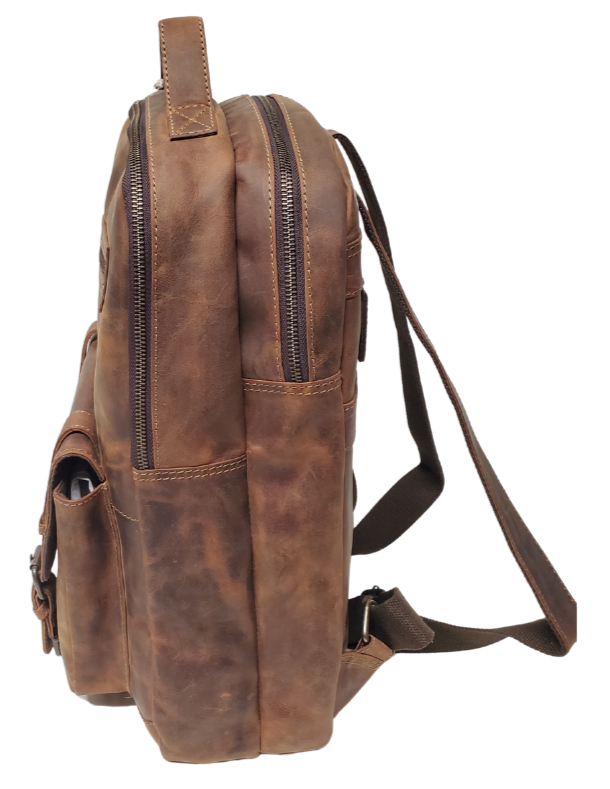 The Governor Leather Backpack is a Classic bag that can carry everything you need for a busy week. Crafted from Distressed leather that will gain a vintage look over time. It features 2 main zippered compartments, a laptop sleeve, space for documents. The magnetic clasp pocket in the front is perfect for power cords. Plus, the adjustable shoulder straps make for a comfortable fit. The back strap easily slides onto your carryon for stress-free travel. Swing by our Smyrna, TN location and snag yours today!