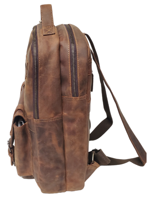 The Governor Leather Backpack is a Classic bag that can carry everything you need for a busy week. Crafted from Distressed leather that will gain a vintage look over time. It features 2 main zippered compartments, a laptop sleeve, space for documents. The magnetic clasp pocket in the front is perfect for power cords. Plus, the adjustable shoulder straps make for a comfortable fit. The back strap easily slides onto your carryon for stress-free travel. Swing by our Smyrna, TN location and snag yours today!