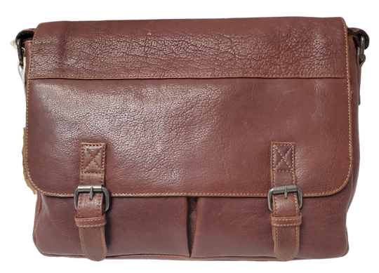 The General Leather Messenger Bag is perfect for the working week, with a traditional style and soft pebble grain leather that only improves with use. It features a main zippered pocket for your laptop, paperwork, and even some snacks, along with two side pockets secured by magnetic clasps for power cords. Plus, the adjustable shoulder strap and back strap make it perfect for any travel needs. Swing by our shop in Smyrna, TN and get yours today!