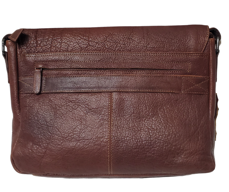The General Leather Messenger Bag is perfect for the working week, with a traditional style and soft pebble grain leather that only improves with use. It features a main zippered pocket for your laptop, paperwork, and even some snacks, along with two side pockets secured by magnetic clasps for power cords. Plus, the adjustable shoulder strap and back strap make it perfect for any travel needs. Swing by our shop in Smyrna, TN and get yours today!