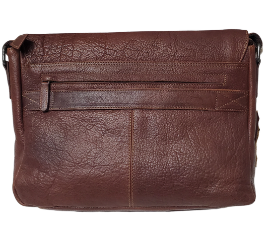 The General Leather Messenger Bag is perfect for the working week, with a traditional style and soft pebble grain leather that only improves with use. It features a main zippered pocket for your laptop, paperwork, and even some snacks, along with two side pockets secured by magnetic clasps for power cords. Plus, the adjustable shoulder strap and back strap make it perfect for any travel needs. Swing by our shop in Smyrna, TN and get yours today!