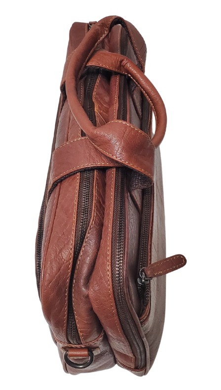 The Colonel Leather Laptop Bag is a no-frills bag that's perfect for the daily hustle. Crafted from buttery soft pebble grain leather, it only gets better with age. With a spacious main pocket, computer sleeve, and room for paperwork and snacks, it's got your weekday needs covered. Power cords? No problem! Just stash them in one of the two outside zippered pockets. And for ultimate convenience, it comes with an adjustable shoulder strap. Swing by our Smyrna, TN shop and snag one today!