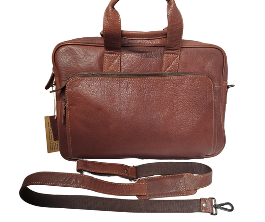 The Colonel Leather Laptop Bag is a no-frills bag that's perfect for the daily hustle. Crafted from buttery soft pebble grain leather, it only gets better with age. With a spacious main pocket, computer sleeve, and room for paperwork and snacks, it's got your weekday needs covered. Power cords? No problem! Just stash them in one of the two outside zippered pockets. And for ultimate convenience, it comes with an adjustable shoulder strap. Swing by our Smyrna, TN shop and snag one today!