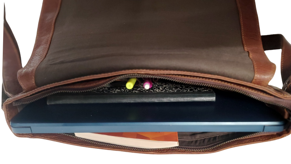 The General Leather Messenger Bag is perfect for the working week, with a traditional style and soft pebble grain leather that only improves with use. It features a main zippered pocket for your laptop, paperwork, and even some snacks, along with two side pockets secured by magnetic clasps for power cords. Plus, the adjustable shoulder strap and back strap make it perfect for any travel needs. Swing by our shop in Smyrna, TN and get yours today!