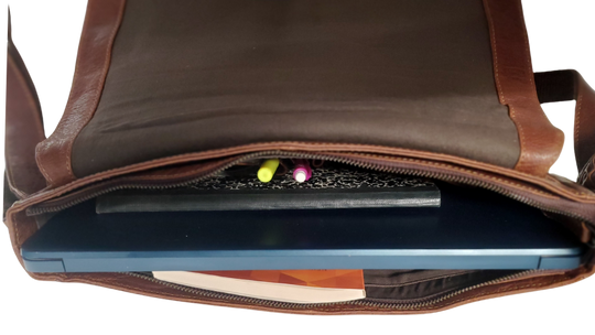 The General Leather Messenger Bag is perfect for the working week, with a traditional style and soft pebble grain leather that only improves with use. It features a main zippered pocket for your laptop, paperwork, and even some snacks, along with two side pockets secured by magnetic clasps for power cords. Plus, the adjustable shoulder strap and back strap make it perfect for any travel needs. Swing by our shop in Smyrna, TN and get yours today!