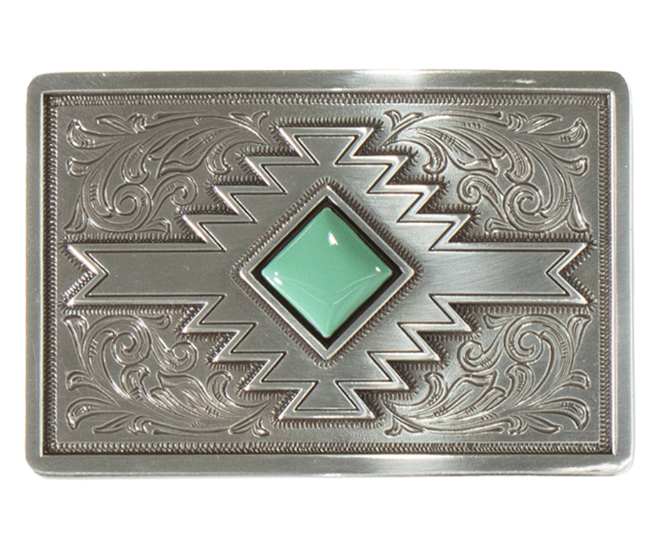 Imagine a beautiful Southwestern landscape with cacti, mountains, and a stunning sunset. Let our "Rio Arroyo" Belt Buckle transport you there with its charming western floral and Navajo-inspired pattern, complete with a vibrant turquoise colored stone at the center. Measuring about 2 1/4" tall by 3 1/4" wide, this buckle fits belts up to 1 1/2" wide and is available for purchase at our retail store in Smyrna, TN, just outside of Nashville.