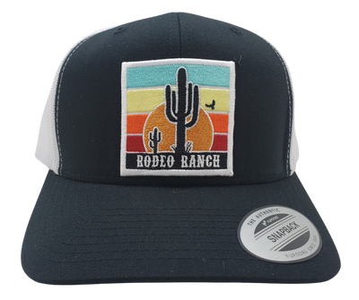 Embrace the thrill of the Rodeo. This Embroidered Trucker Cap features a vibrant desert sun and a towering Cactus. With a Black front, White mesh trucker style, and a snapped adjustable strap, it's ready for any adventure. Visit our Smyrna, TN shop just outside Nashville and claim yours today!