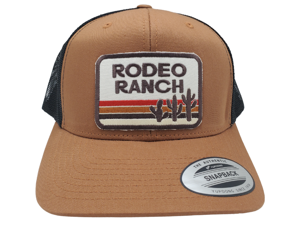 Get ready for your night out with our Rodeo Ranch Retro Cap! This trendy Embroidered Trucker Cap boasts a bold sandy color, hot desert vibes, and an iconic cactus design. Featuring a cool black mesh back, a stylish tan front, and a convenient snapped adjustable strap. Grab yours today at our shop in Smyrna, TN, right outside Nashville