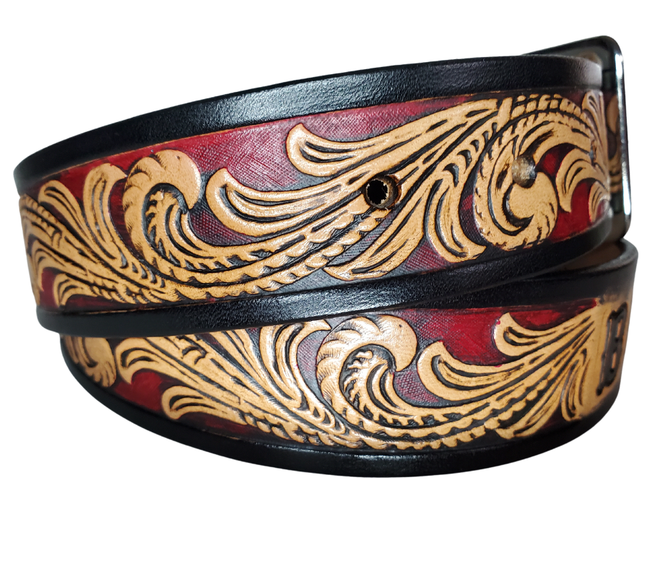 This DELUXE Rustler Name Leather Belt features a classic western Scroll pattern embossed on a 9-10 oz vegetable-tanned cowhide. You may customize the buckle with the added snaps. It is named Deluxe because of the additional color added to the background of the pattern. This product is crafted with care in our Smyrna, TN shop, just outside Nashville, TN.      