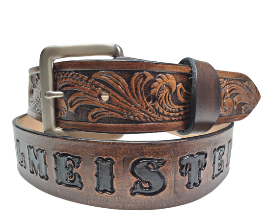 Our Rustler Name Leather Belt is Full grain American vegetable tanned cowhide approx. 1/8"thick. Width 1 1/2" and includes Antique Nickle plated Solid Brass buckle. Hand Finished and Smooth burnished painted edges. Choose with or without name, if without name, design will cover entire length of belt. For name Type name desired on belt in "Type Name Here" section, no more than 10 letters maximum. Buckle snaps in place for easy changing if desired. Made in our Smyrna, TN, USA shop.