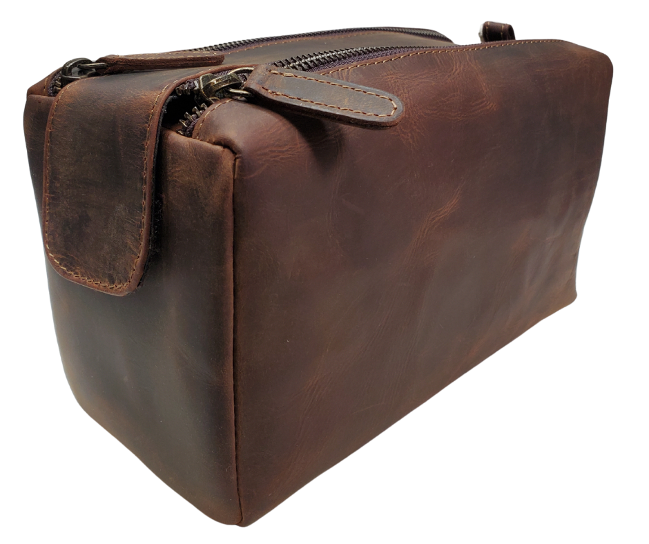 The Representative, a Distressed Brown Leather traveling Dopp bag, is available at our Smyrna, TN shop not far from Nashville. It has one outside zip pocket, side handle, and a two-zipper & closure with hook-and-loop securing the end. Spacious main compartment with a zip pocket on one side and three elastic loops on the other side. Lined with a slick fabric.
Bag size: 9.25” x 3.5” x 5.5”