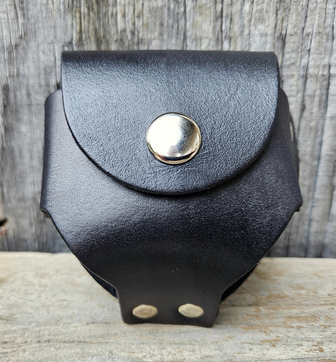 Made in USA Leather case to hold a can of snuff. Attaches to your belt with a loop on the back. Snap closure. Available in Black or Brown. Available online and in our retail shop in Smyrna, TN.