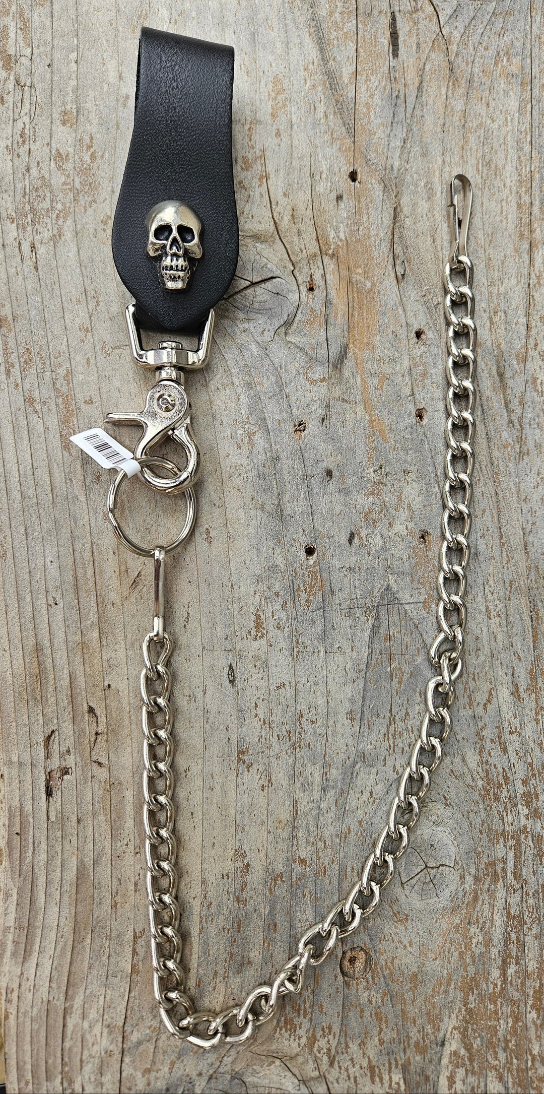 This Vintage style Steel Chain with a Skull Head Concho. Simple but Sturdy and will keep your wallet where it needs to be. The Leather loop, decorated with a Skull concho, attaches to your jeans and the split ring attaches to your wallet. Chrome plated. Ride down and get yours in our shop just outside Nashville in Smyrna, TN.

18" Chain Length
Leather belt tab