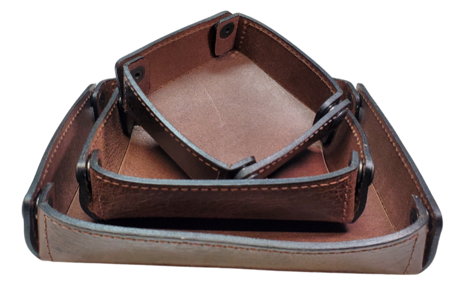 The Capitol Valet Travel Tray is our handmade valet tray is 1 layer of Water Buffalo leather. It's a little different than our other tray because it's more of a Rectangle/Square shape. The corners are held together with heavy line 24 Antique Brass colored snaps, for laying flat for travel, a place for placing keys, wallet, coins, etc. Made in our shop just outside Nashville in Smyrna, TN.

Small is Approx. 4"x 4"
Medium is approx. 4"x6"
Large is approx. 8"x 6"