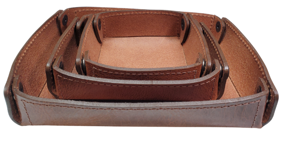 The Capitol Valet Travel Tray is our handmade valet tray is 1 layer of Water Buffalo leather. It's a little different than our other tray because it's more of a Rectangle/Square shape. The corners are held together with heavy line 24 Antique Brass colored snaps, for laying flat for travel, a place for placing keys, wallet, coins, etc. Made in our shop just outside Nashville in Smyrna, TN.

Small is Approx. 4"x 4"
Medium is approx. 4"x6"
Large is approx. 8"x 6"