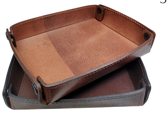 The Capitol Valet Travel Tray is our handmade valet tray is 1 layer of Water Buffalo leather. It's a little different than our other tray because it's more of a Rectangle/Square shape. The corners are held together with heavy line 24 Antique Brass colored snaps, for laying flat for travel, a place for placing keys, wallet, coins, etc. Made in our shop just outside Nashville in Smyrna, TN.

Small is Approx. 4"x 4"
Medium is approx. 4"x6"
Large is approx. 8"x 6"