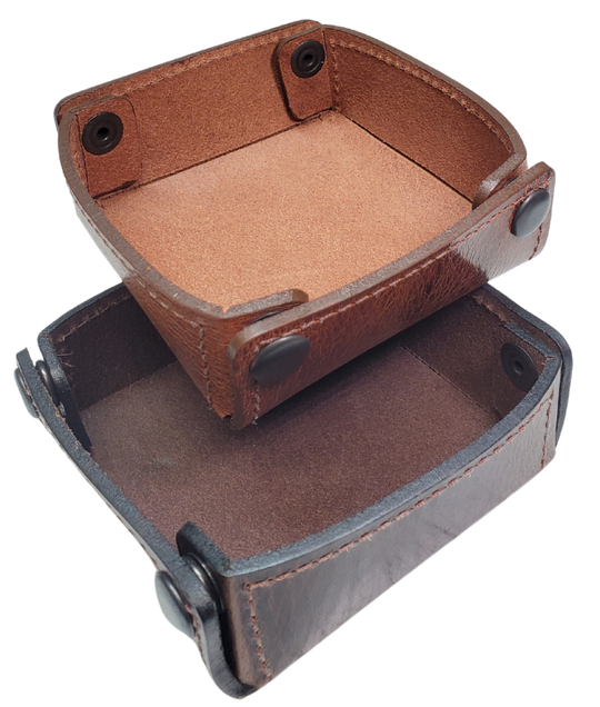 The Capitol Valet Travel Tray is our handmade valet tray is 1 layer of Water Buffalo leather. It's a little different than our other tray because it's more of a Rectangle/Square shape. The corners are held together with heavy line 24 Antique Brass colored snaps, for laying flat for travel, a place for placing keys, wallet, coins, etc. Made in our shop just outside Nashville in Smyrna, TN.

Small is Approx. 4"x 4"
Medium is approx. 4"x6"
Large is approx. 8"x 6"