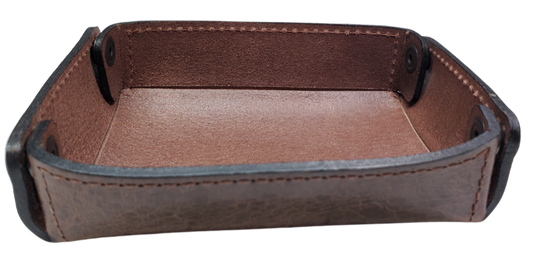The Capitol Valet Travel Tray is our handmade valet tray is 1 layer of Water Buffalo leather. It's a little different than our other tray because it's more of a Rectangle/Square shape. The corners are held together with heavy line 24 Antique Brass colored snaps, for laying flat for travel, a place for placing keys, wallet, coins, etc. Made in our shop just outside Nashville in Smyrna, TN.

Small is Approx. 4"x 4"
Medium is approx. 4"x6"
Large is approx. 8"x 6"