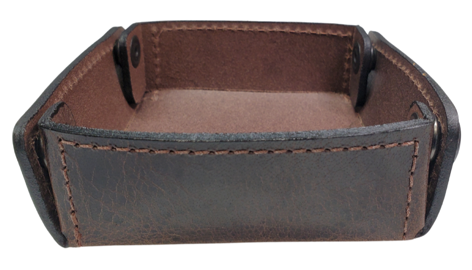 The Capitol Valet Travel Tray is our handmade valet tray is 1 layer of Water Buffalo leather. It's a little different than our other tray because it's more of a Rectangle/Square shape. The corners are held together with heavy line 24 Antique Brass colored snaps, for laying flat for travel, a place for placing keys, wallet, coins, etc. Made in our shop just outside Nashville in Smyrna, TN.

Small is Approx. 4"x 4"
Medium is approx. 4"x6"
Large is approx. 8"x 6"