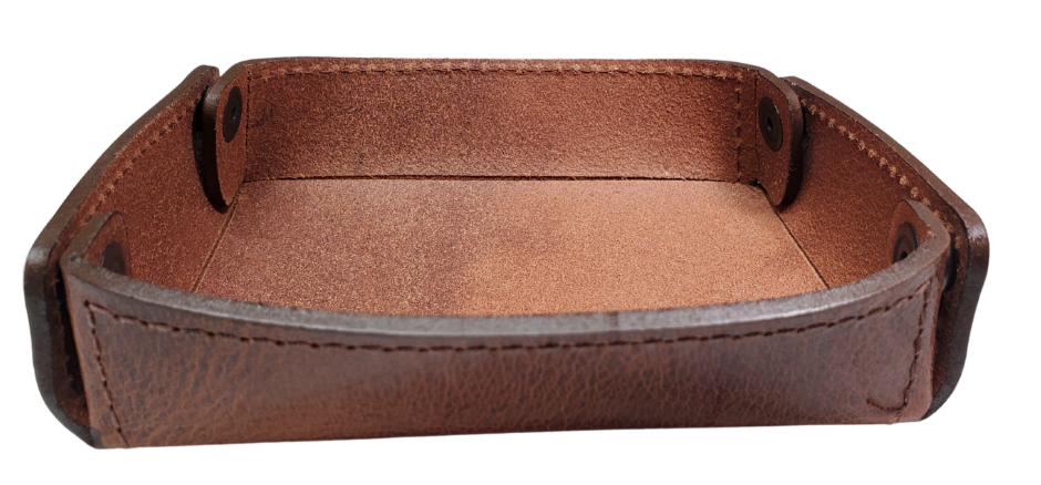 The Capitol Valet Travel Tray is our handmade valet tray is 1 layer of Water Buffalo leather. It's a little different than our other tray because it's more of a Rectangle/Square shape. The corners are held together with heavy line 24 Antique Brass colored snaps, for laying flat for travel, a place for placing keys, wallet, coins, etc. Made in our shop just outside Nashville in Smyrna, TN.

Small is Approx. 4"x 4"
Medium is approx. 4"x6"
Large is approx. 8"x 6"