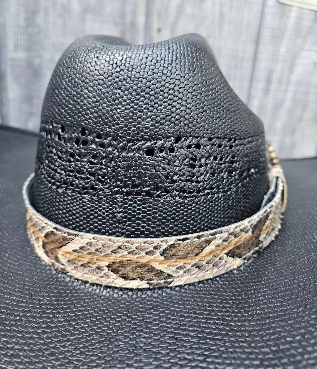 This Natural Copper Canyon Eastern Canebrake Rattlesnake Skin Hatband has a Rattle at the end of the band. It has more a Striped Copper pattern than a traditional Diamondback. Actual snakeskin with a pigskin backing and adjustment with a Velcro loop that you can tighten or loose to fit your favorite hats. You can bring your hat and try them out if you come to our Smyrna, TN shop not far from Nashville.

1" width