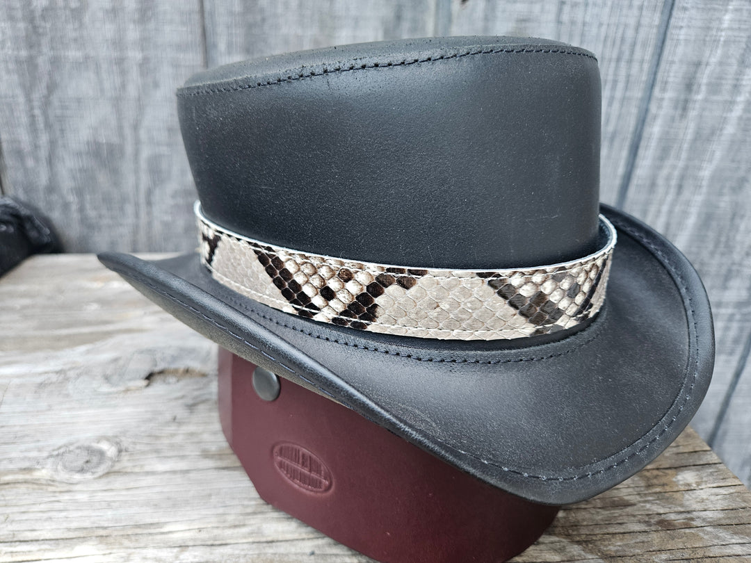 The Headliner Python Snake Skin Hatband is cut to show the back pattern. This band is 1" in width and adjust with a Velcro loop that you can tighten or loose to fit your favorite hats. You can bring your hat and try them out if you come to our Smyrna, TN shop not far from Nashville.

Please keep in mind the patterns will ALWAYS vary since this is a natural skin, these are NOT manufactured skins.
Center Cut is a more defined scale pattern&amp;nbsp;
Side cut has more a mix of colors